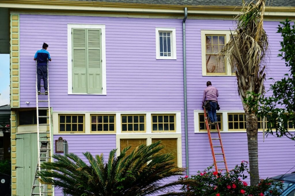 Painters working on house exterior