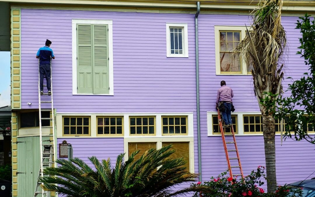 Painters working on house exterior